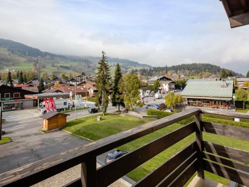 a view from a balcony of a town with a parking lot at Résidence Hôtel Rent - Megève in Megève