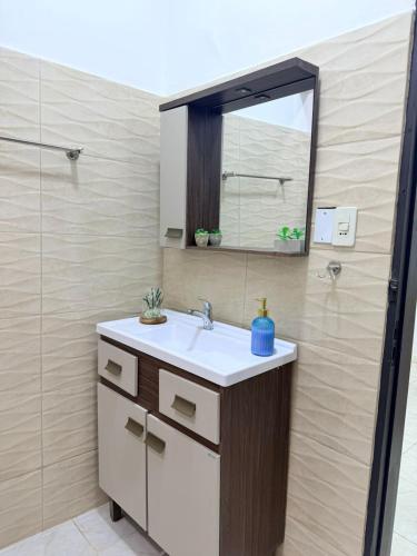 a bathroom with a sink and a mirror at GuestHouse Encanto del Centro 4 in Encarnación