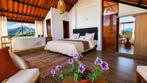 a bedroom with a bed and a tub and a couch at Mi Shalita in Santa Cruz
