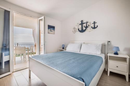 a bedroom with a bed and a view of the ocean at Costa Paradiso Sea View - 8 Guests in Trinità d'Agultu e Vignola