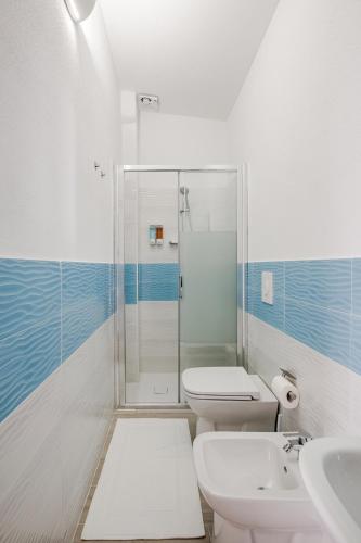 a bathroom with a shower and a toilet and a sink at Costa Paradiso Sea View - 8 Guests in Trinità d'Agultu e Vignola