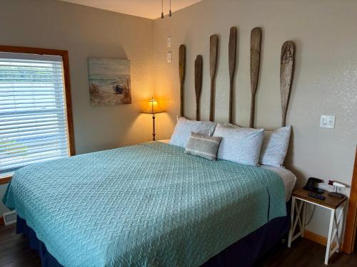 a bedroom with a bed with a blue comforter at Mississippi River Cabin in Bellevue