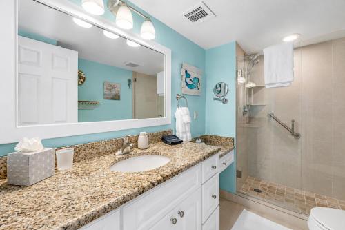 a bathroom with a sink and a shower at Waterfront Island Oasis! Heated Pool with Stunning View & 2 Full Bath in Marco Island