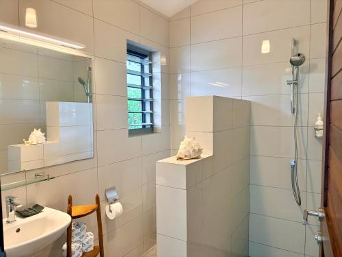 a bathroom with a shower and a sink at The Namele Villas in Port Vila
