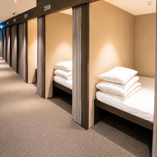 a row of bunk beds in a room with mirrors at OstelloMaree 오스텔로마레 Tax Benefit in Seoul