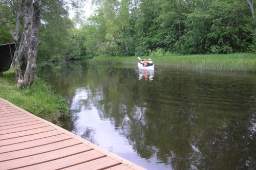 a couple of people in a boat on a river at Lonni Nature Eco-Accommodation in Hagudi