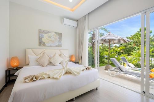 a bedroom with a bed and a sliding glass door at Villa Kiru in Koh Samui