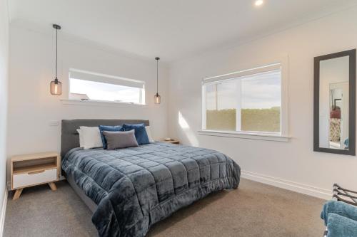 a bedroom with a bed and a window at 19 Broadway in Martinborough