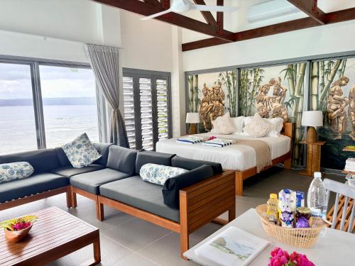a living room with a bed and a couch at The Namele Villas in Port Vila