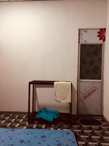a room with a table and a towel on a wall at KR Villa in Arugam Bay