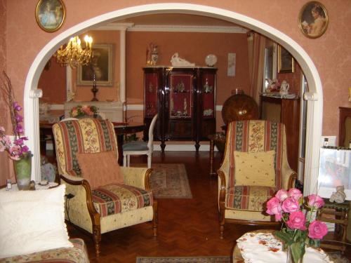 a living room with two chairs and a table at Chambres d'Hôtes Ty Mezad in Séné