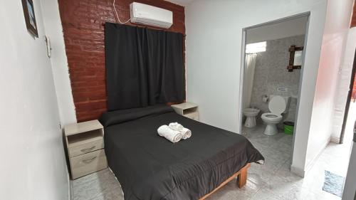 a bedroom with a bed with a towel on it at Apartamentos Villa Jardin in Reyes