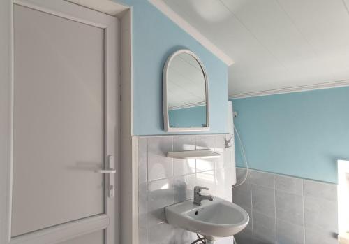 a bathroom with a sink and a mirror at OSTRIV Hotel in Zatoka