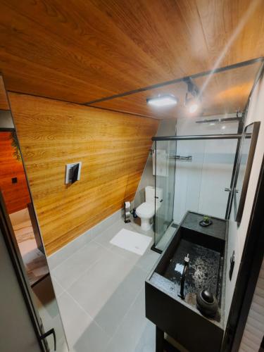 a bathroom with a glass shower and a sink at Cabana dos Colibris in Santa Teresa