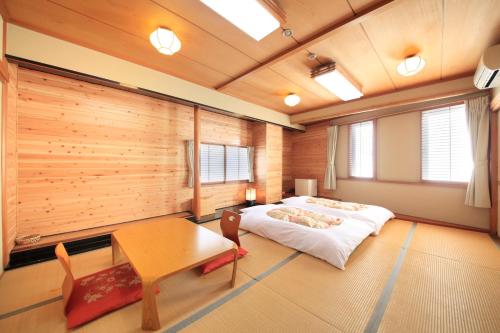 Postel nebo postele na pokoji v ubytování Fujinomiya Green Hotel