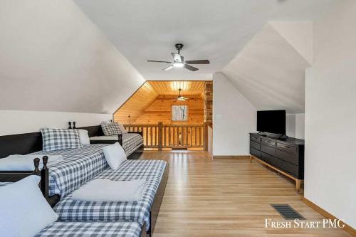 a living room with couches and a flat screen tv at Cabin in Wellston in Wellston