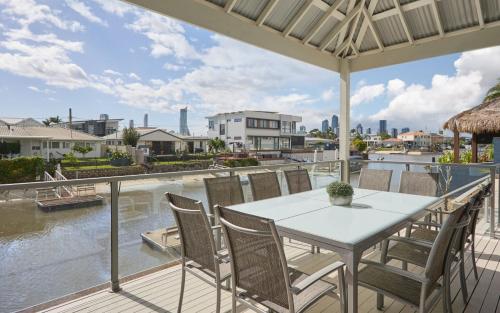a table and chairs on a balcony with a view of the water at Oasis By Khove - Broadbeach Waters in Gold Coast