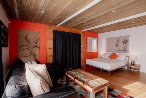 a living room with a couch and a bed at Ruby SoHo Workshop Villa in Port Sorell