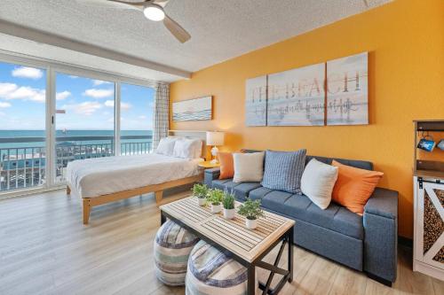 a living room with a bed and a couch in a room at Amazing Large Private Studio Condo with Amazing View in Myrtle Beach