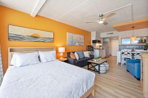 a bedroom with a bed and a living room at Amazing Large Private Studio Condo with Amazing View in Myrtle Beach