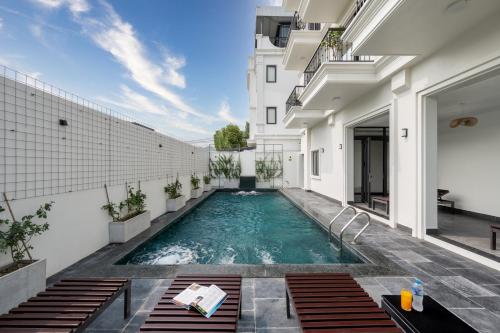 an indoor swimming pool in the middle of a building at Aluna Tam Coc Hotel in Ninh Binh