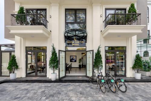 two bikes parked in front of a building at Aluna Tam Coc Hotel in Ninh Binh