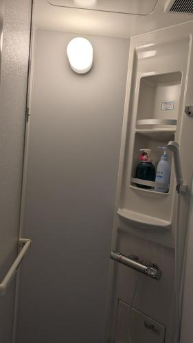 a refrigerator door with a bottle of water in it at 奄美ザナゼステイTheNazeStay in Amami