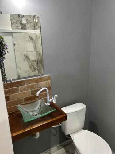 a bathroom with a sink and a toilet at Catavento in Paty do Alferes