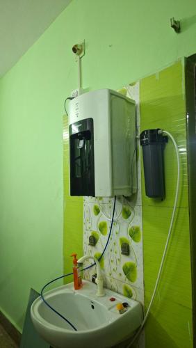 a bathroom with a sink and a microwave at Atithi Stay in Bhubaneshwar