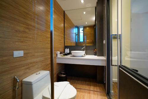 a bathroom with a white toilet and a sink at Hanoi Amsterdam Art Studio in Da Lat
