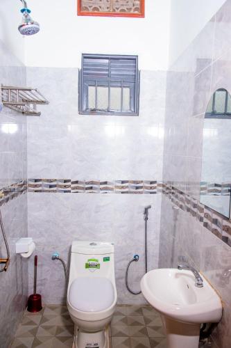 a bathroom with a toilet and a sink at Kasese Explorers Homestay in Kasese