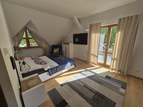 a bedroom with a bed and a large window at Ranczo Brusno in Połczyn-Zdrój