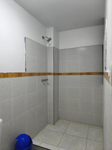 a shower with a glass door in a bathroom at Hostal jm in Huancayo