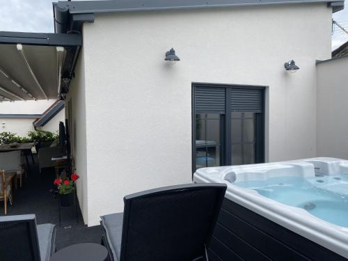 a hot tub on the patio of a house at Petite Mansion in Našice