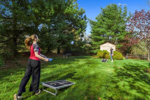 two people playing a game of frisbee in a yard at Grammy's Famous Lake House Retreat in East Hampton