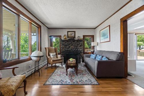 a living room with a couch and a fireplace at Grammy's Famous Lake House Retreat in East Hampton