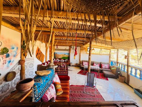 a living room filled with lots of furniture at Tizaou Guest House in Taghazout