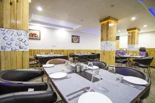 a dining room with tables and chairs in a restaurant at Mountain Mount view # triund track 2 km#Free Parking-cricket stadium 8 km-Mcleodganj 2 km in Dharamshala