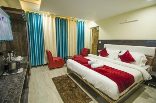 a bedroom with a large bed with a teddy bear on it at Mountain Mount view # triund track 2 km#Free Parking-cricket stadium 8 km-Mcleodganj 2 km in Dharamshala