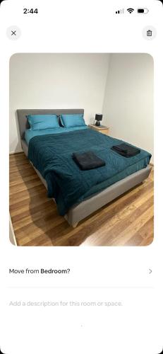 a bedroom with a bed with blue pillows at Lavish private room1 in Truganina