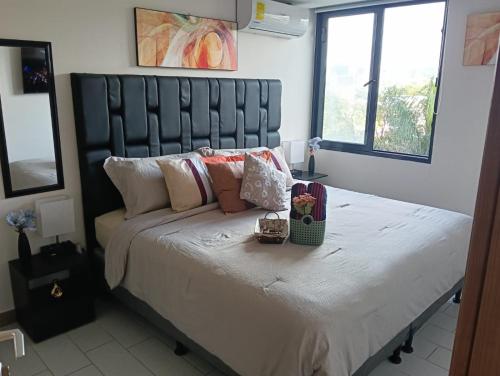 a bedroom with a large bed with white sheets and pillows at Apartamento ignacio in Tegucigalpa