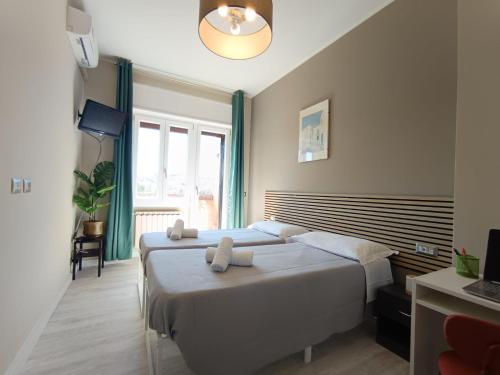 a bedroom with a bed with two towels on it at Appartamento Turistico Monterotondo in Monterotondo