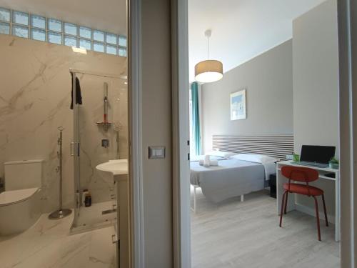 a bathroom with a tub and a bedroom with a bed at Appartamento Turistico Monterotondo in Monterotondo