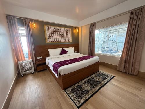 a bedroom with a bed and a window at The Pham Inn in Bomdila