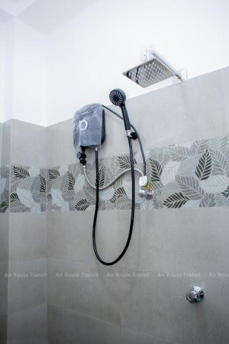 a shower with a shower head in a bathroom at Air Route Transit in Seeduwa