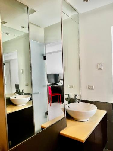 two sinks in a bathroom with a mirror at The Upperhouse Hotel Boutique Stay with City & River Views in Cagayan de Oro