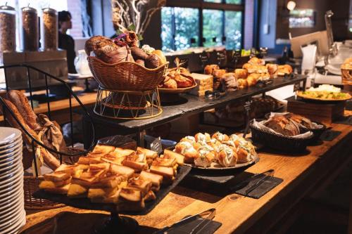a buffet with many different types of bread and pastries at THE KNOT TOKYO Shinjuku in Tokyo