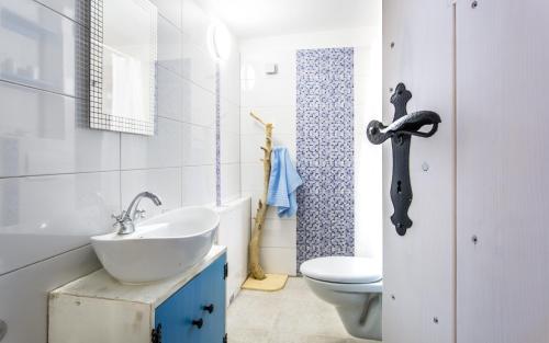 a bathroom with a white sink and a toilet at Villa Cima in Vrbnik
