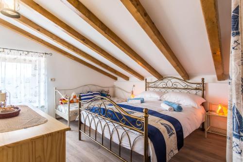 a bedroom with two beds and a window at Villa Cima in Vrbnik