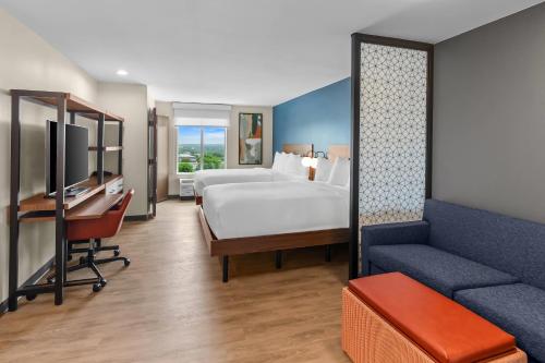 a hotel room with a bed and a couch at Everhome Suites Georgetown - Austin in Georgetown